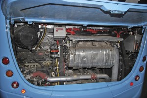 The engine bay with the exhaust system prominent. The hydraulic equipment associated with the steering will disappear when the system is electrified