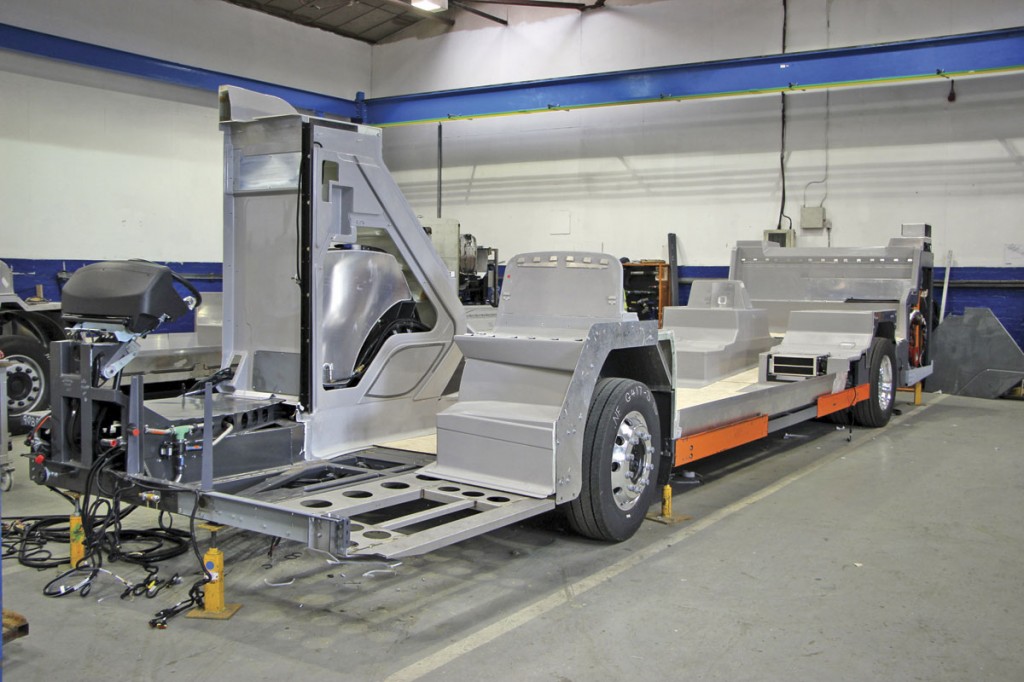 An Enviro400 chassis. The blue steelwork visible in the background is part of the new cranage system for lifting the GRP sections into place