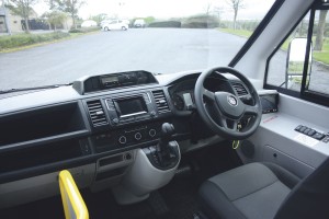 The well laid out cab is largely VW transporter. Note the well integrated body system switches on the driver’s right and the reversing camera screen. Vision through the large deep screen is excellent -1