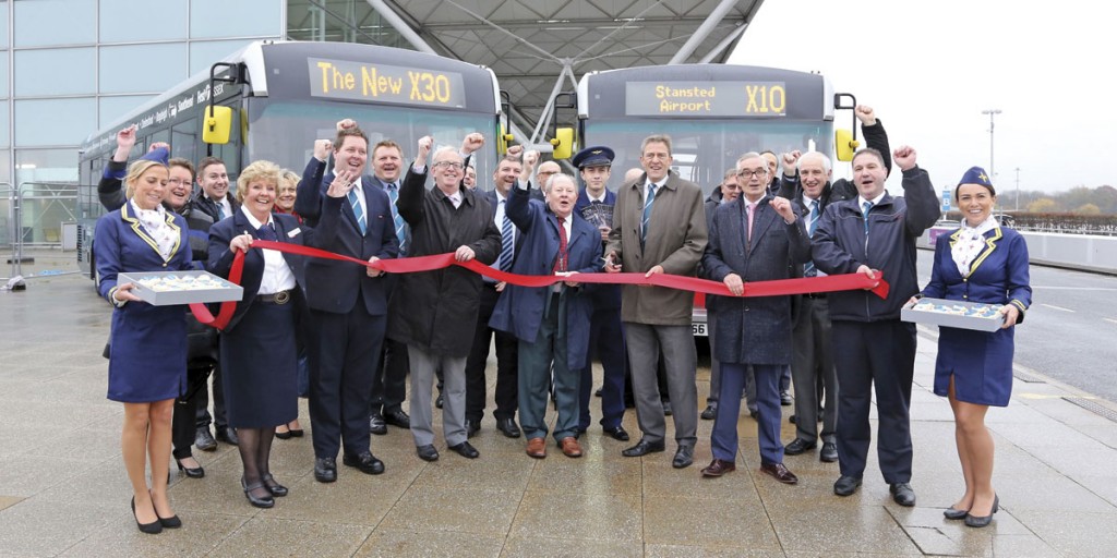 The formal launch with Alex Jones, Managing Director of First Essex, holding the scissors. Neil Banks, Head of Passenger Services at Stansted Airport is to his left and Ray Howard, Essex County Council, Deputy Cabinet Member for Highways and Transport to his right.