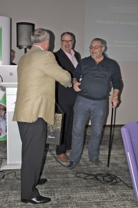 Mick McElhone of Plaxton collects the prize in the Premier Plus champagne draw from Kevin Hull and Chris Clark