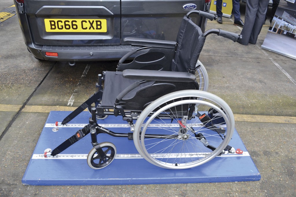 The Koller EXCEL 120. Combined wheelchair restraint is demonstrated here. Customers were encouraged to sit in the chair and test the stability