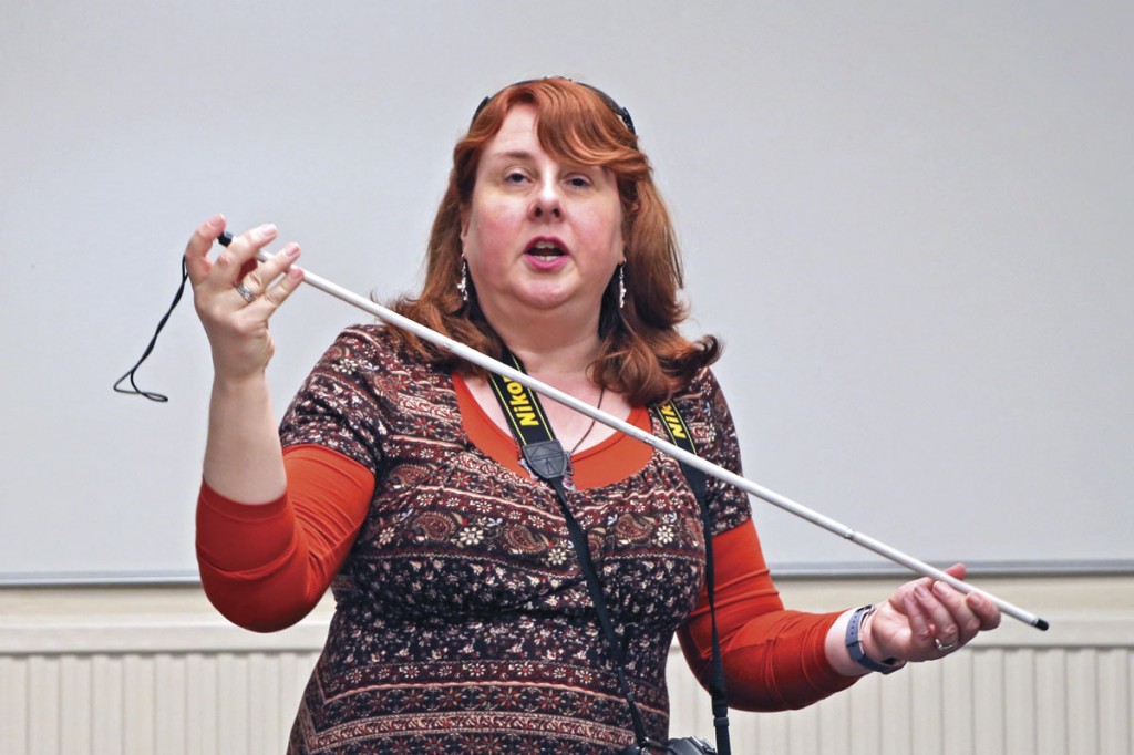 Natalie Doig, RNIB National Campaign Officer, demonstrates a symbol cane