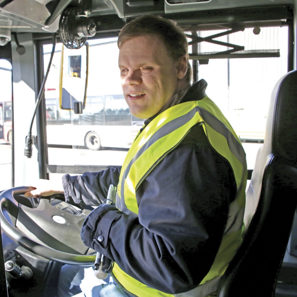 Paul Bryce greeting passengers from the drivers seat of an Enviro400 MMC