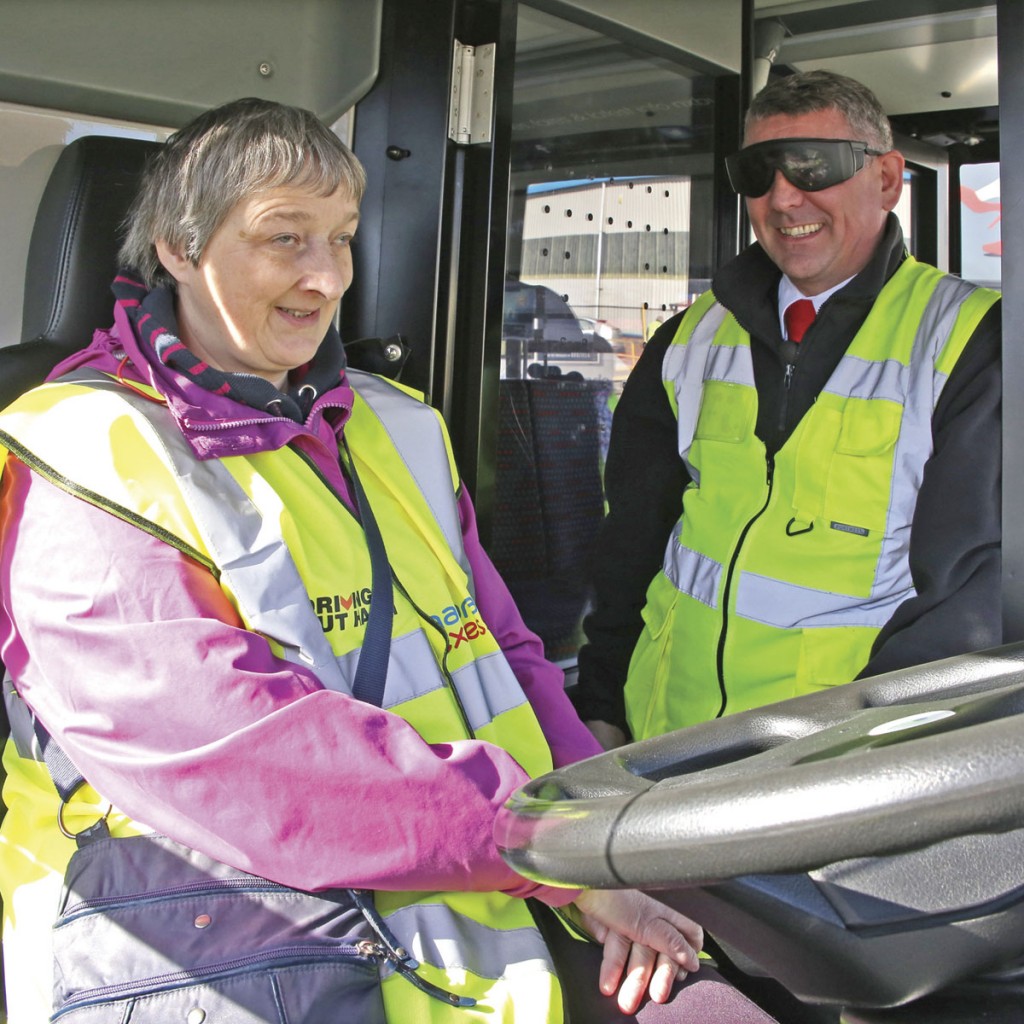 Sharon Gibbs in the cab with driver trainer Stephen Hill wearing sim specs