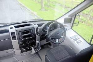 The cab is essentially Mercedes-Benz Sprinter. Note the neat Mellor control panel to the driver’s right for the body systems and the rear view camera screen