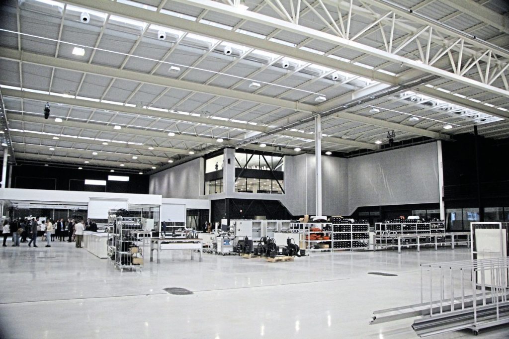 Offices are located in the corner of the facility. Ahead of them are component assembly areas