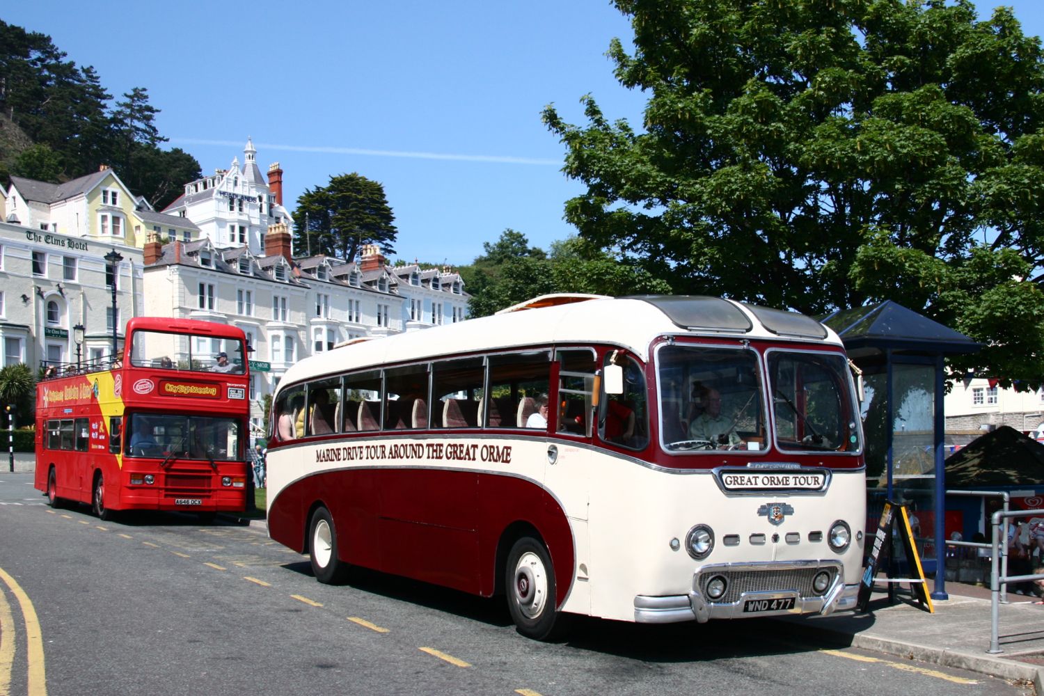 The Duple Britannia at the Pier with an earlier generation of open-top bus behind