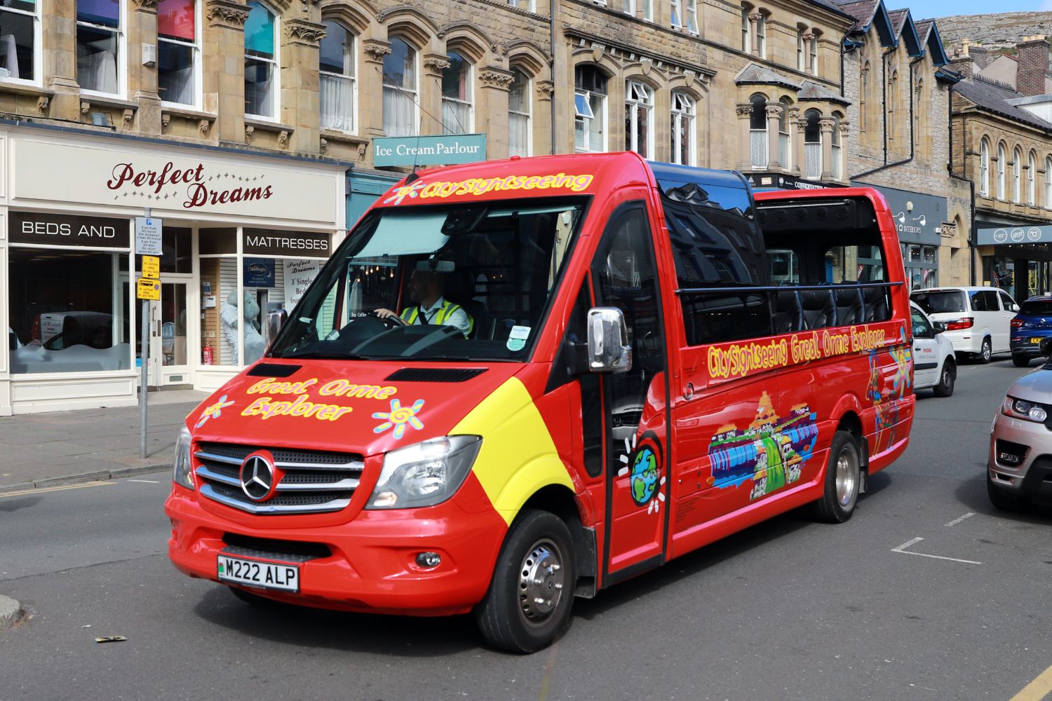 The two CarBus Cabriolet Mercedes-Benz Sprinters can be rapidly closed if the weather changes. This one is appropriately open on a sunny day in Llandudno town centre