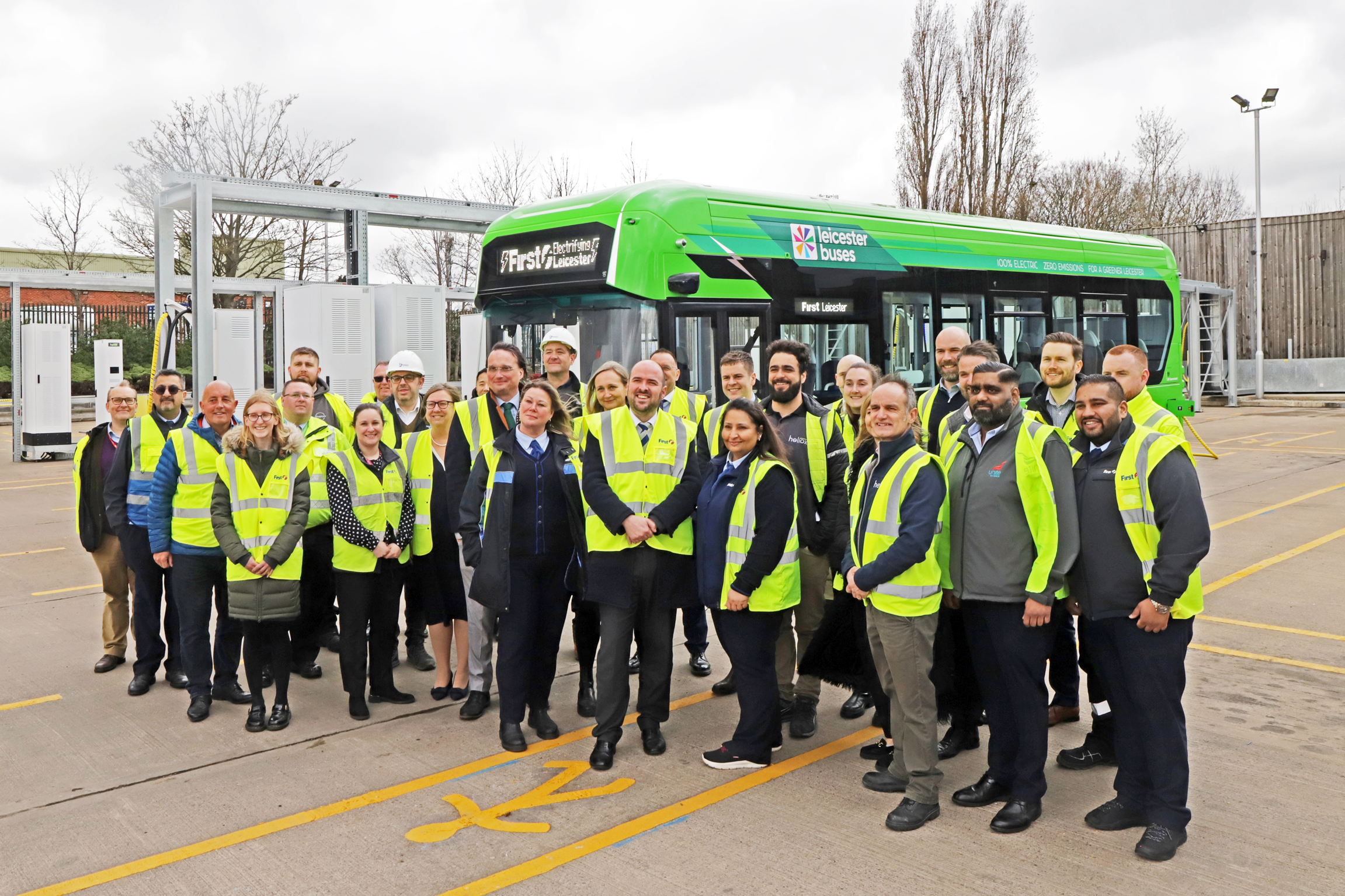 Project partners join Transport Minister, Richard Holden MP (centre) to formally launch First Leicester’s electric buses at the Abbey Lane depot